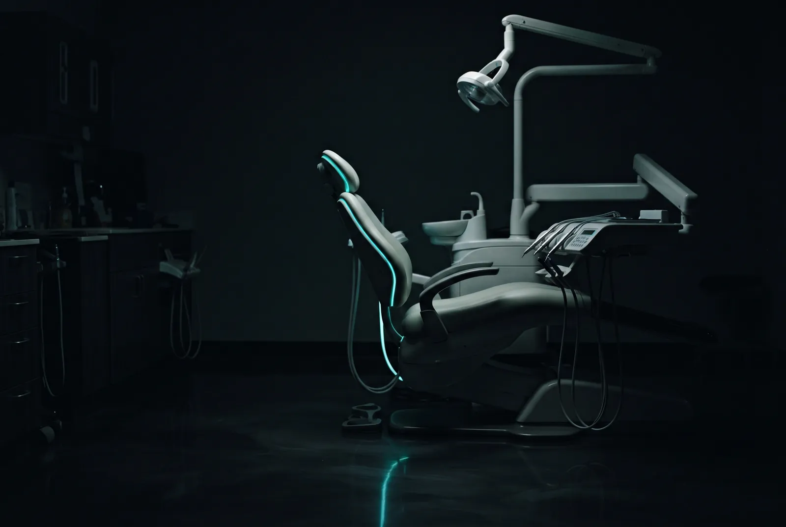 Empty dental treatment chair in a darkened clinic after hours